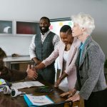 A group of diverse professionals engaged in a collaborative business meeting indoors.