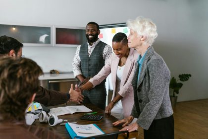 A group of diverse professionals engaged in a collaborative business meeting indoors.