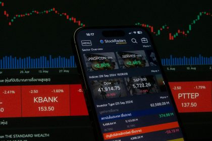 Close-up of a digital stock trading app interface with investment charts and market trends displayed.