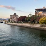 Scenic view of Hiroshima Peace Memorial Park with autumn foliage along the river.