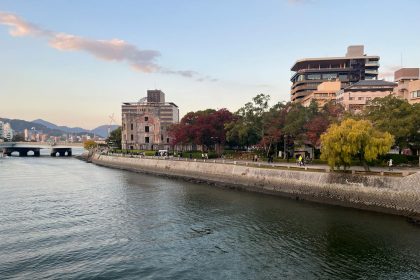 Scenic view of Hiroshima Peace Memorial Park with autumn foliage along the river.