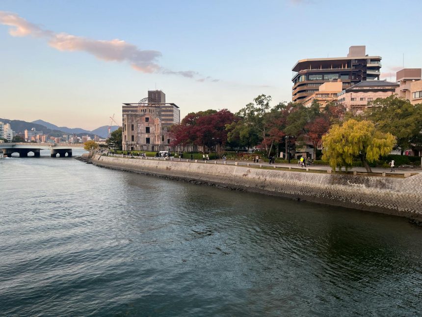 Scenic view of Hiroshima Peace Memorial Park with autumn foliage along the river.